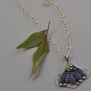 Torch-fired Coneflower necklace by Lynn Gardner, guest artist at Wenaha Gallery